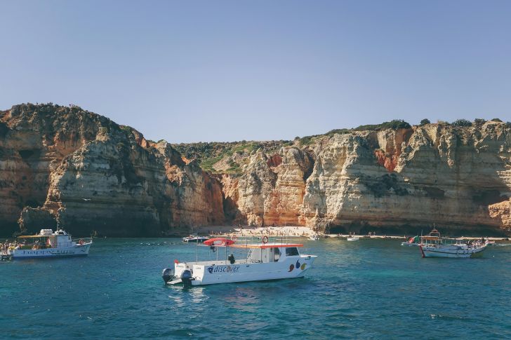 White Boats in the Water in Front of a Coast